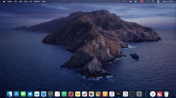 macOS Catalina dock with badge on System Preferences dock